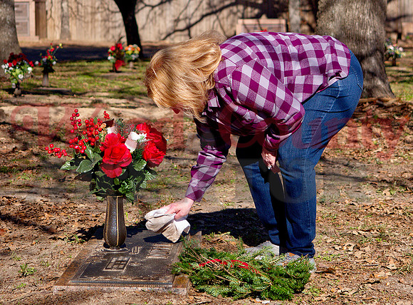 _1306390 Sherry Dupre cleans headstone of Michael Dupre