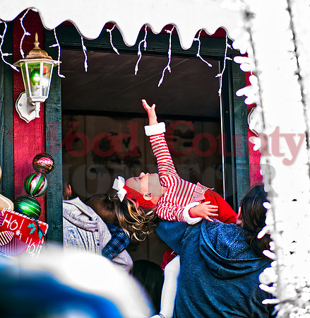 _1218462 Kalylie Gilbreath reaches for icecicle lights